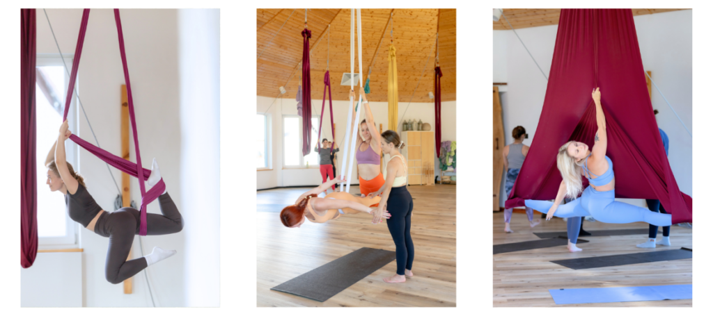 Three students practicing different aerial dance poses with support during a workshop on red and white hammocks.